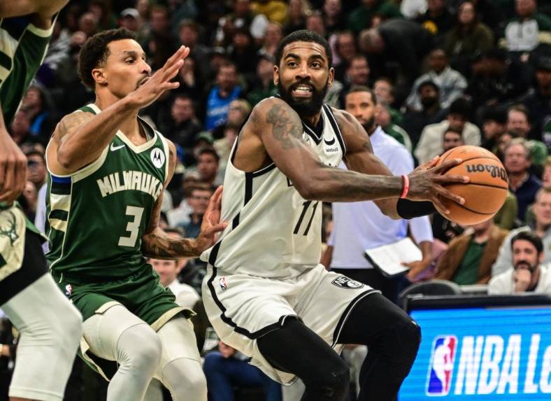 Oct 26, 2022; Milwaukee, Wisconsin, USA; Brooklyn Nets guard Kyrie Irving (11) drives to the basket against Milwaukee Bucks guard George Hill (3) in the fourth quarter at Fiserv Forum. Mandatory Credit: Benny Sieu-USA TODAY Sports