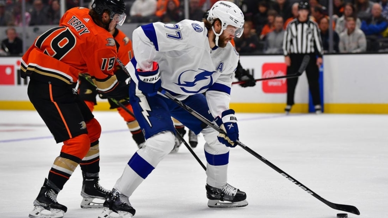 Oct 26, 2022; Anaheim, California, USA; Tampa Bay Lightning defenseman Victor Hedman (77) moves the puck against Anaheim Ducks right wing Troy Terry (19) during the first period at Honda Center. Mandatory Credit: Gary A. Vasquez-USA TODAY Sports
