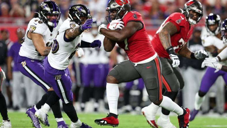 Oct 27, 2022; Tampa, Florida, USA;  Tampa Bay Buccaneers running back Leonard Fournette (7) runs with the ball against the Baltimore Ravens in the first quarter at Raymond James Stadium. Mandatory Credit: Nathan Ray Seebeck-USA TODAY Sports