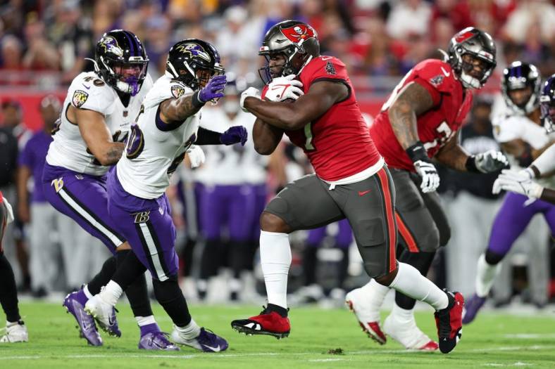 Oct 27, 2022; Tampa, Florida, USA;  Tampa Bay Buccaneers running back Leonard Fournette (7) runs with the ball against the Baltimore Ravens in the first quarter at Raymond James Stadium. Mandatory Credit: Nathan Ray Seebeck-USA TODAY Sports