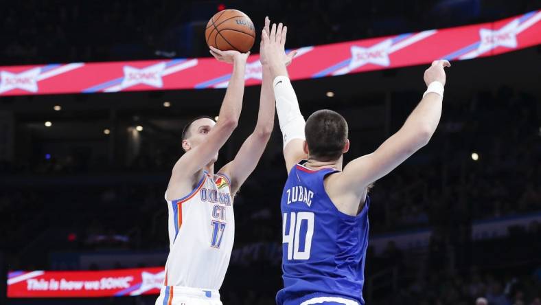 Oct 27, 2022; Oklahoma City, Oklahoma, USA; Oklahoma City Thunder forward Aleksej Pokusevski (17) shoots as LA Clippers center Ivica Zubac (40) defends the shot during the first half at Paycom Center. Mandatory Credit: Alonzo Adams-USA TODAY Sports