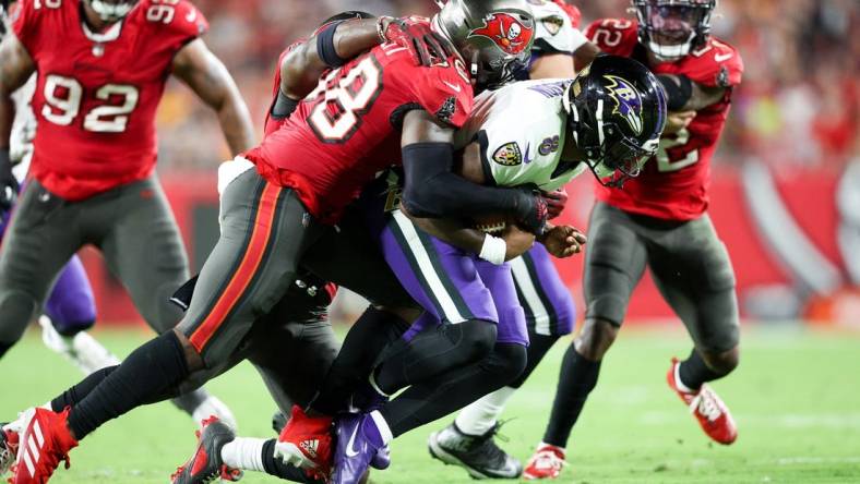 Oct 27, 2022; Tampa, Florida, USA;  Tampa Bay Buccaneers linebacker Shaquil Barrett (58) sacks Baltimore Ravens quarterback Lamar Jackson (8) in the second quarter at Raymond James Stadium. Mandatory Credit: Nathan Ray Seebeck-USA TODAY Sports