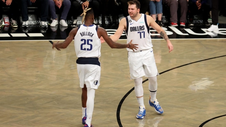 Oct 27, 2022; Brooklyn, New York, USA; Dallas Mavericks guard Luka Doncic (77) celebrates with forward Reggie Bullock (25) during overtime against the Brooklyn Nets at Barclays Center. Mandatory Credit: Brad Penner-USA TODAY Sports