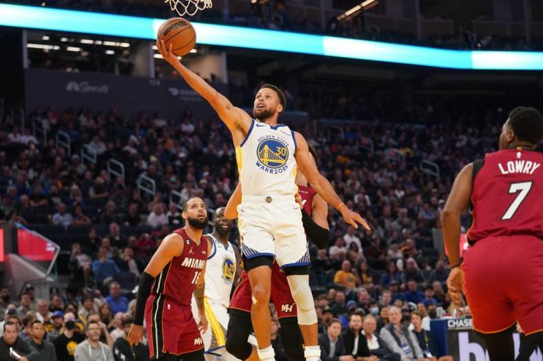 Oct 27, 2022; San Francisco, California, USA; Golden State Warriors guard Stephen Curry (30) makes a layup against the Miami Heat in the second quarter at the Chase Center. Mandatory Credit: Cary Edmondson-USA TODAY Sports