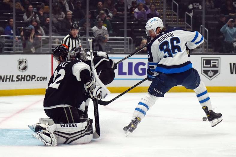 Oct 27, 2022; Los Angeles, California, USA; LA Kings goaltender Jonathan Quick (32) defends the goal against Winnipeg Jets center Morgan Barron (36) in the first period at Crypto.com Arena. Mandatory Credit: Kirby Lee-USA TODAY Sports