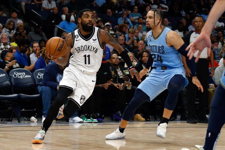 Oct 24, 2022; Memphis, Tennessee, USA; Brooklyn Nets guard Kyrie Irving (11) drives to the basket as Memphis Grizzlies forward Dillon Brooks (24) defends during the second half at FedExForum. Mandatory Credit: Petre Thomas-USA TODAY Sports