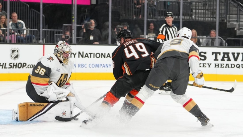 Oct 28, 2022; Las Vegas, Nevada, USA; Vegas Golden Knights goaltender Logan Thompson (36) makes a save against Anaheim Ducks left wing Max Jones (49)  during the first period at T-Mobile Arena. Mandatory Credit: Stephen R. Sylvanie-USA TODAY Sports