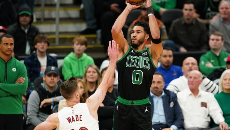 Oct 28, 2022; Boston, Massachusetts, USA; Boston Celtics forward Jayson Tatum (0) shoots for three points against Cleveland Cavaliers forward Dean Wade (32) in the first quarter at TD Garden. Mandatory Credit: David Butler II-USA TODAY Sports