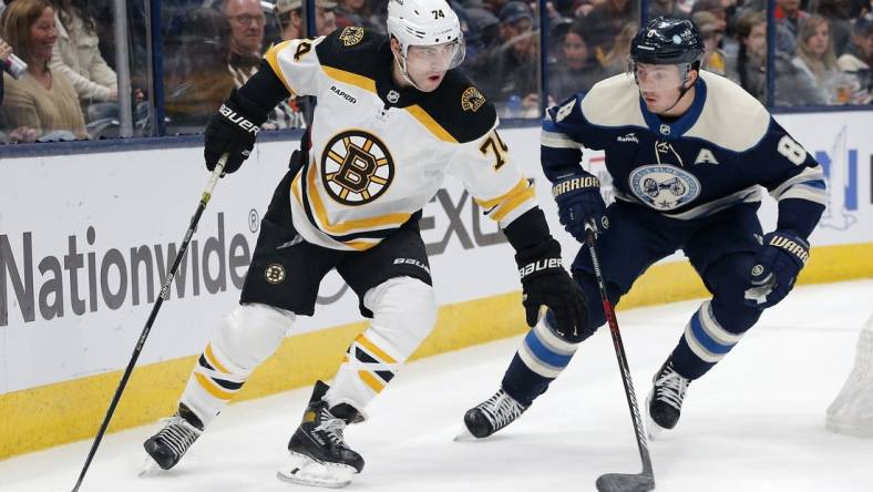 Oct 28, 2022; Columbus, Ohio, USA; Boston Bruins left wing Taylor Hall (71) controls the puck against Columbus Blue Jackets defenseman Zach Werenski (8) during the first period at Nationwide Arena. Mandatory Credit: Russell LaBounty-USA TODAY Sports