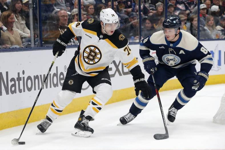 Oct 28, 2022; Columbus, Ohio, USA; Boston Bruins left wing Taylor Hall (71) controls the puck against Columbus Blue Jackets defenseman Zach Werenski (8) during the first period at Nationwide Arena. Mandatory Credit: Russell LaBounty-USA TODAY Sports