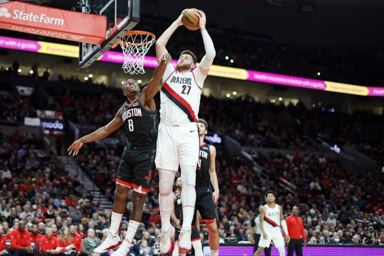 Oct 28, 2022; Portland, Oregon, USA; Portland Trail Blazers center Jusuf Turkic (27) comes down with a rebound next to Houston Rockets small forward Jae'Sean Tate (8) during the first half at Moda Center. Mandatory Credit: Soobum Im-USA TODAY Sports