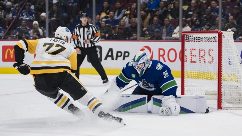 Oct 28, 2022; Vancouver, British Columbia, CAN; Vancouver Canucks goalie Spencer Martin (30) makes a save on Pittsburgh Penguins forward Jeff Carter (77) in the second period at Rogers Arena.  Mandatory Credit: Bob Frid-USA TODAY Sports