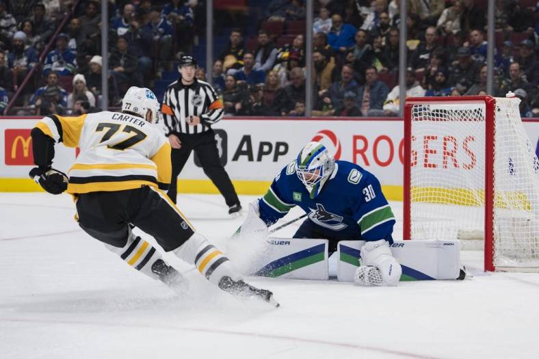 Oct 28, 2022; Vancouver, British Columbia, CAN; Vancouver Canucks goalie Spencer Martin (30) makes a save on Pittsburgh Penguins forward Jeff Carter (77) in the second period at Rogers Arena.  Mandatory Credit: Bob Frid-USA TODAY Sports