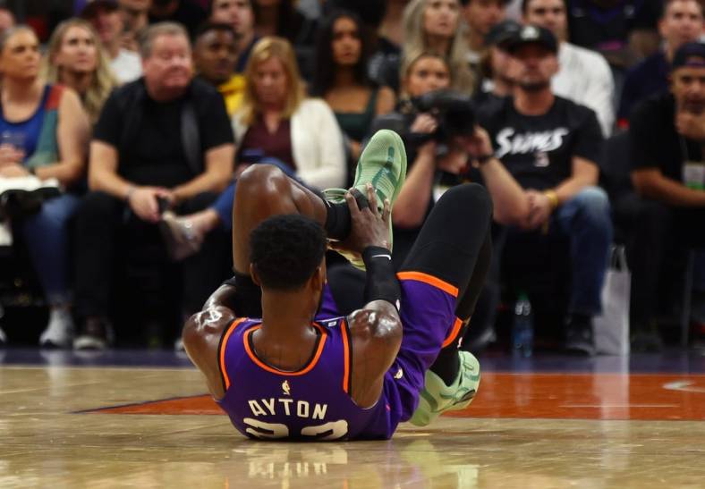 Oct 28, 2022; Phoenix, Arizona, USA; Phoenix Suns center Deandre Ayton (22) grabs his ankle after suffering an injury against the New Orleans Pelicans during the first half at Footprint Center. Mandatory Credit: Mark J. Rebilas-USA TODAY Sports