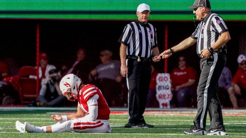 Oct 29, 2022; Lincoln, Nebraska, USA; Nebraska Cornhuskers quarterback Casey Thompson (11) sits on the ground while awaiting medical staff for an injury during the second quarter against the Illinois Fighting Illini at Memorial Stadium. Mandatory Credit: Dylan Widger-USA TODAY Sports