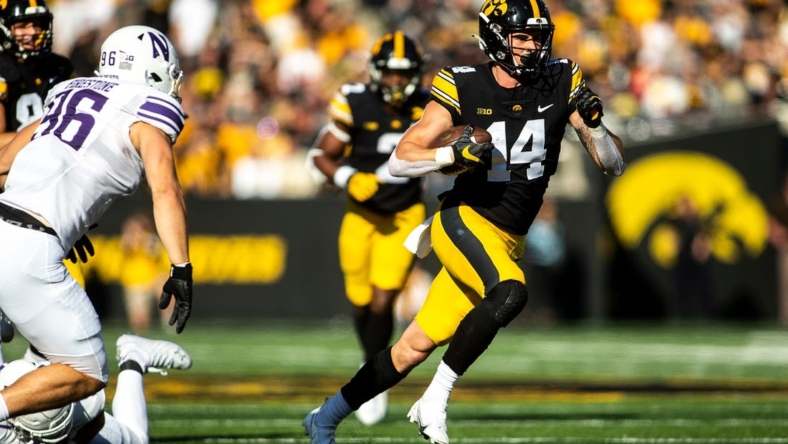 Iowa wide receiver Brody Brecht (14) runs for extra yards during a NCAA Big Ten Conference football game against Northwestern, Saturday, Oct. 29, 2022, at Kinnick Stadium in Iowa City, Iowa.

221029 Northwestern Iowa Fb 024 Jpg