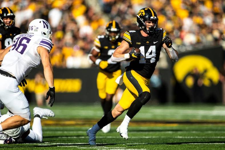 Iowa wide receiver Brody Brecht (14) runs for extra yards during a NCAA Big Ten Conference football game against Northwestern, Saturday, Oct. 29, 2022, at Kinnick Stadium in Iowa City, Iowa.

221029 Northwestern Iowa Fb 024 Jpg