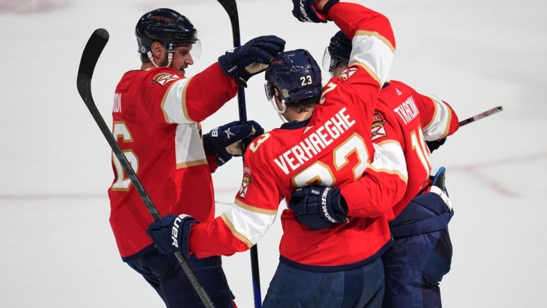 Oct 29, 2022; Sunrise, Florida, USA; Florida Panthers center Carter Verhaeghe (23) celebrates a goal in the second period against the Ottawa Senators with teammates center Aleksander Barkov (16) and left wing Matthew Tkachuk (19) at FLA Live Arena. Mandatory Credit: Jim Rassol-USA TODAY Sports