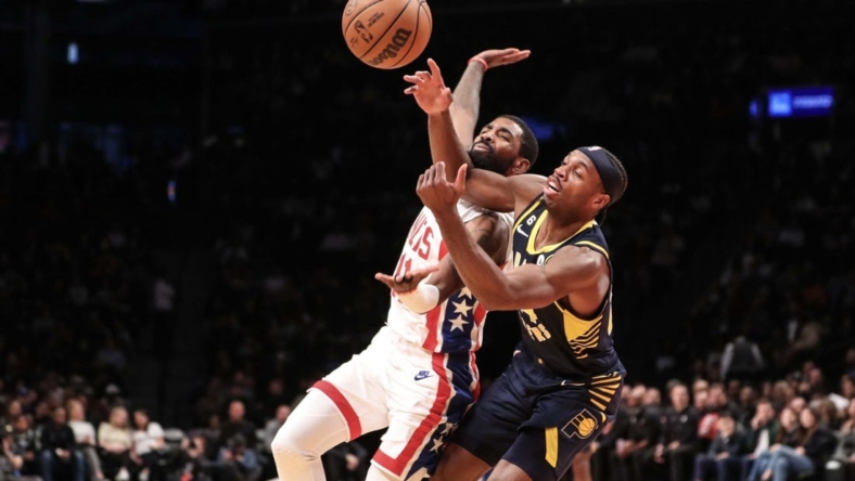 Oct 29, 2022; Brooklyn, New York, USA;  Brooklyn Nets guard Kyrie Irving (11) and Indiana Pacers guard Buddy Hield (24) fight for a loose ball in the second quarter at Barclays Center. Mandatory Credit: Wendell Cruz-USA TODAY Sports