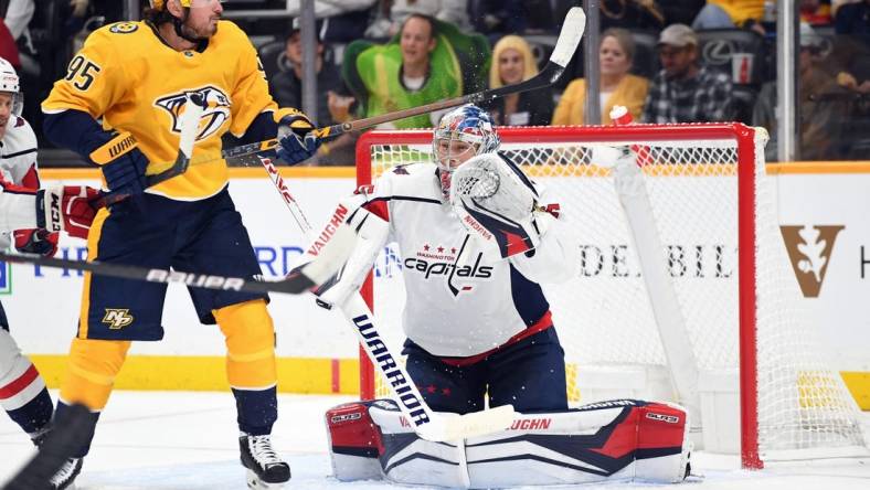 Oct 29, 2022; Nashville, Tennessee, USA; Washington Capitals goaltender Darcy Kuemper (35) watches as a shot is deflected by Nashville Predators center Matt Duchene (95) during the first period at Bridgestone Arena. Mandatory Credit: Christopher Hanewinckel-USA TODAY Sports