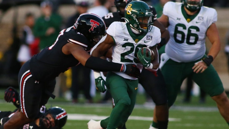 Oct 29, 2022; Lubbock, Texas, USA;  Baylor Bears running back Richard Reese (29) rushes against Texas Tech Red Raiders defensive linebacker Tyree Wilson (19) in the first half at Jones AT&T Stadium and Cody Campbell Field. Mandatory Credit: Michael C. Johnson-USA TODAY Sports