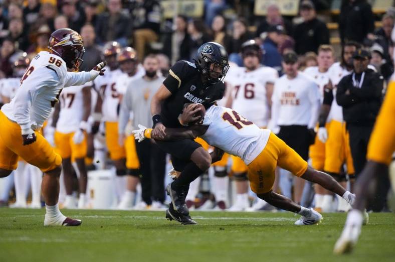 Oct 29, 2022; Boulder, Colorado, USA; Arizona State Sun Devils defensive back Ed Woods (10) tackles Colorado Buffaloes quarterback Drew Carter (9) in the first quarter at Folsom Field. Mandatory Credit: Ron Chenoy-USA TODAY Sports