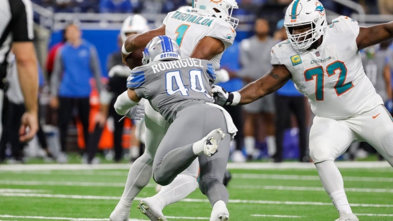 Detroit Lions linebacker Malcolm Rodriguez tackles Miami Dolphins quarterback Tua Tagovailoa during the first half at Ford Field in Detroit on Sunday, Oct. 30, 2022.