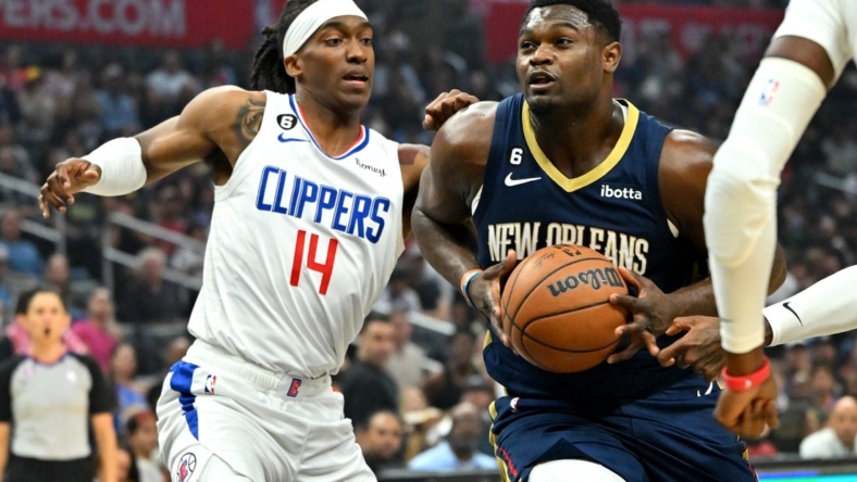 Oct 30, 2022; Los Angeles, California, USA;  Los Angeles Clippers guard Terance Mann (14) defends New Orleans Pelicans forward Zion Williamson (1) as he drive to the basket in the first half at Crypto.com Arena. Mandatory Credit: Jayne Kamin-Oncea-USA TODAY Sports