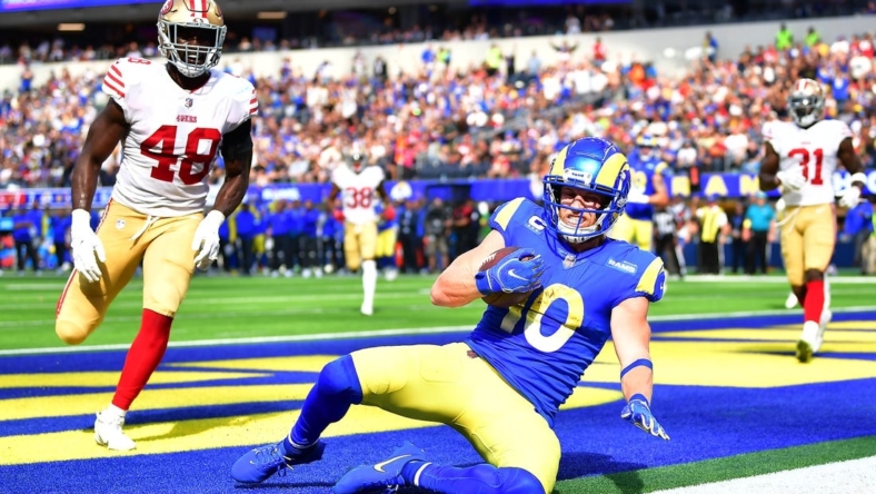 Oct 30, 2022; Inglewood, California, USA; Los Angeles Rams wide receiver Cooper Kupp (10) scores a touchdown ahead of San Francisco 49ers linebacker Oren Burks (48) during the first half at SoFi Stadium. Mandatory Credit: Gary A. Vasquez-USA TODAY Sports