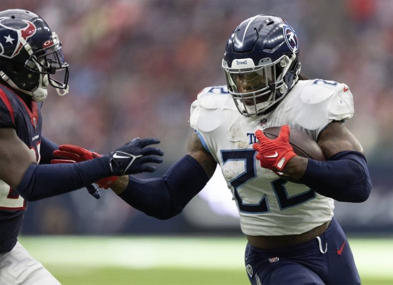 Oct 30, 2022; Houston, Texas, USA; Tennessee Titans running back Derrick Henry (22) rushes for a touchdown against Houston Texans cornerback Desmond King II (25) in the second quarter at NRG Stadium. Mandatory Credit: Thomas Shea-USA TODAY Sports