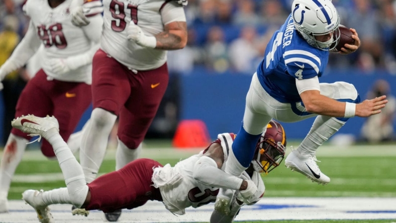 Washington Commanders safety Kamren Curl (31) works to bring down Indianapolis Colts quarterback Sam Ehlinger (4) on Sunday, Oct. 30, 2022, during a game against the Washington Commanders at Indianapolis Colts at Lucas Oil Stadium in Indianapolis.