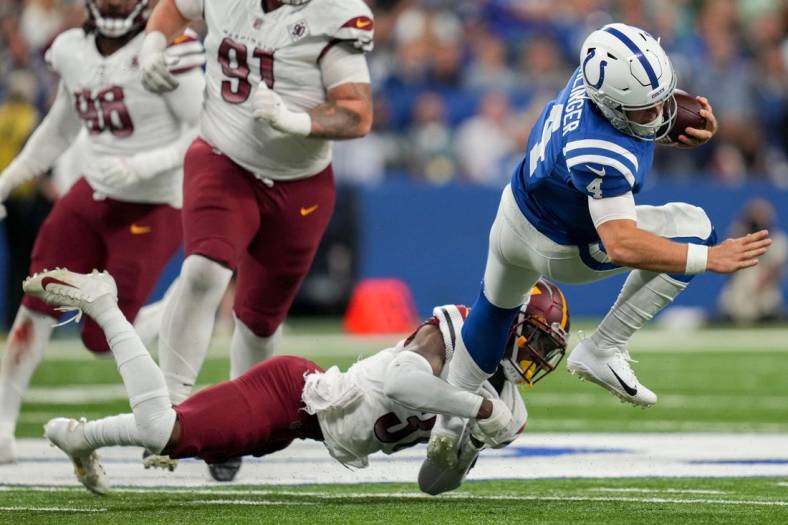 Washington Commanders safety Kamren Curl (31) works to bring down Indianapolis Colts quarterback Sam Ehlinger (4) on Sunday, Oct. 30, 2022, during a game against the Washington Commanders at Indianapolis Colts at Lucas Oil Stadium in Indianapolis.