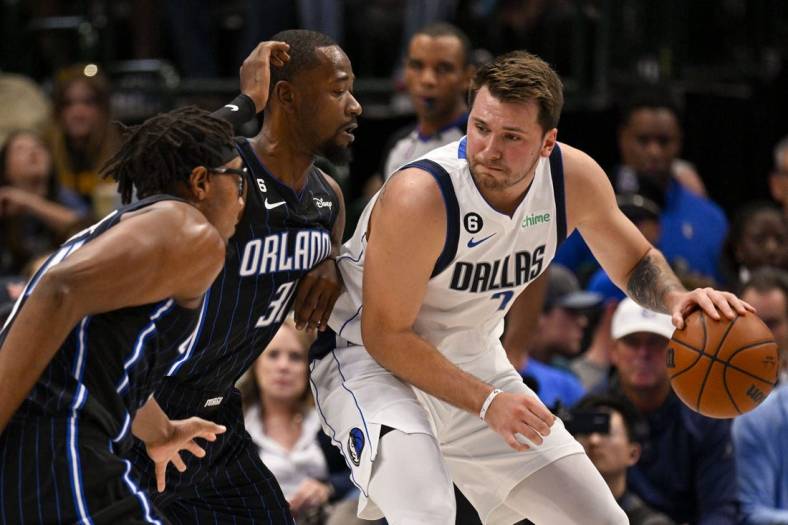 Oct 30, 2022; Dallas, Texas, USA; Orlando Magic guard Terrence Ross (31) defends against Dallas Mavericks guard Luka Doncic (77) during the first quarter at the American Airlines Center. Mandatory Credit: Jerome Miron-USA TODAY Sports