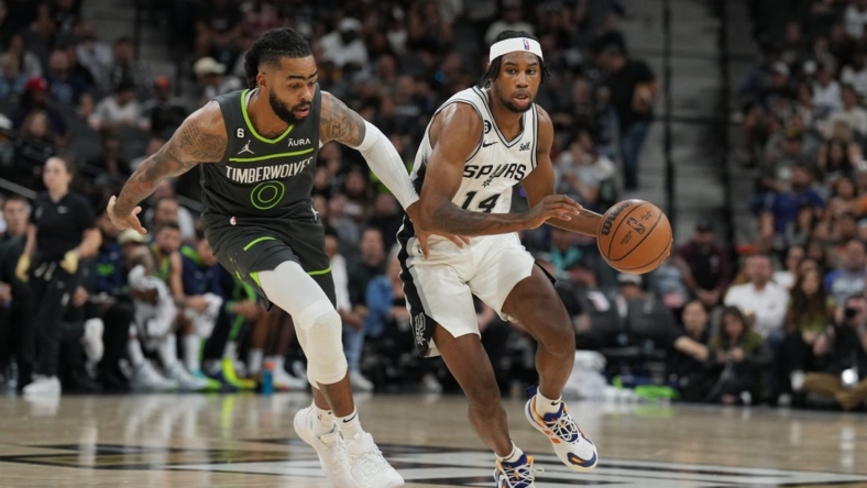 Oct 30, 2022; San Antonio, Texas, USA;  San Antonio Spurs guard Blake Wesley (14) dribbles against Minnesota Timberwolves guard D'Angelo Russell (0) in the first half at the AT&T Center. Mandatory Credit: Daniel Dunn-USA TODAY Sports