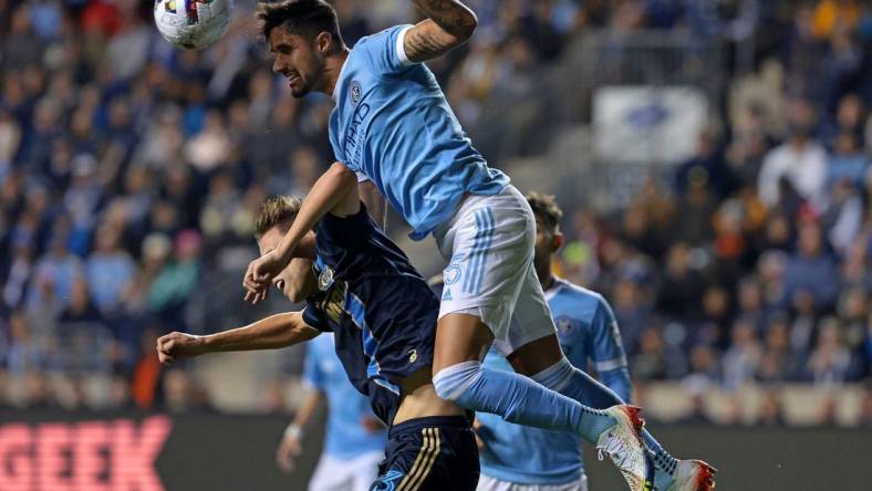 Oct 30, 2022; Philadelphia, Pennsylvania, USA; New York City defender Thiago Martins (5) heads the ball against Philadelphia Union defender Jack Elliott (3)  during the first half for the conference finals for the Audi 2022 MLS Cup Playoffs. Mandatory Credit: Vincent Carchietta-USA TODAY Sports