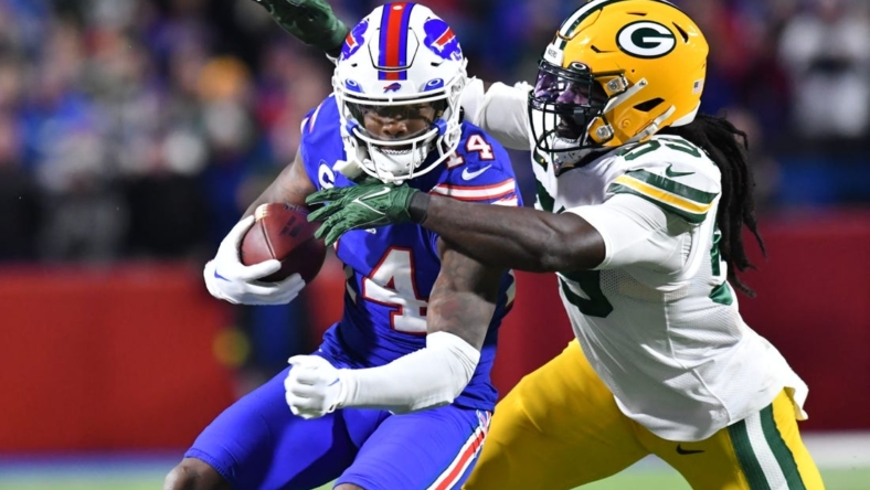 Oct 30, 2022; Orchard Park, New York, USA; Buffalo Bills wide receiver Stefon Diggs (14) is tackled by Green Bay Packers linebacker De'Vondre Campbell (59) after a catch in the second quarter at Highmark Stadium. Mandatory Credit: Mark Konezny-USA TODAY Sports