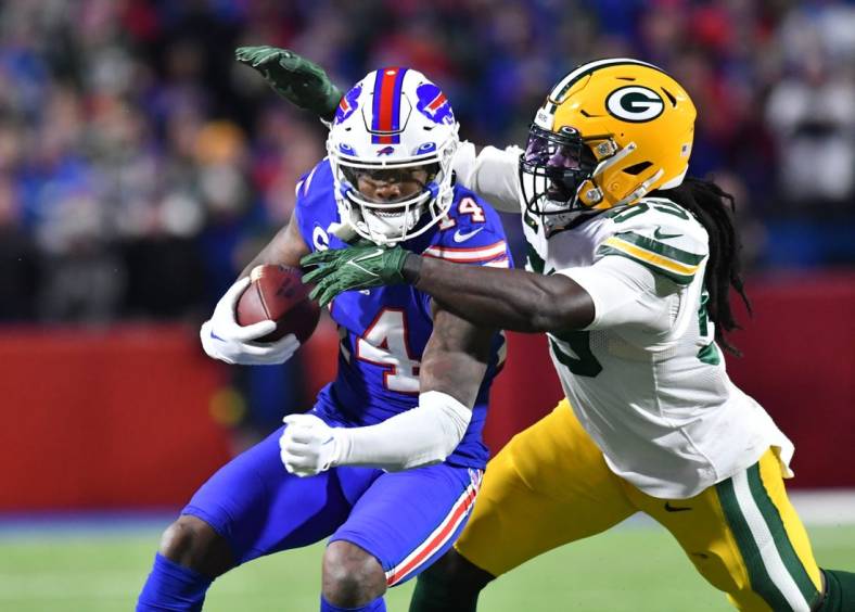 Oct 30, 2022; Orchard Park, New York, USA; Buffalo Bills wide receiver Stefon Diggs (14) is tackled by Green Bay Packers linebacker De'Vondre Campbell (59) after a catch in the second quarter at Highmark Stadium. Mandatory Credit: Mark Konezny-USA TODAY Sports