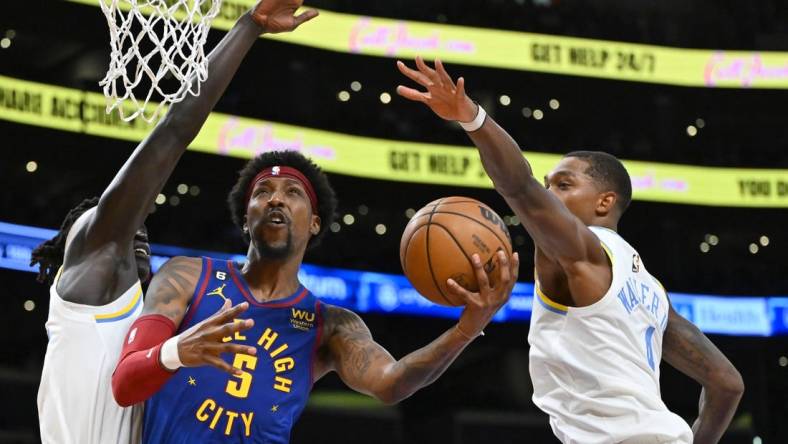 Oct 30, 2022; Los Angeles, California, USA;  Denver Nuggets guard Kentavious Caldwell-Pope (5) is defended by Los Angeles Lakers forward Wenyen Gabriel (35) and Los Angeles Lakers guard Lonnie Walker IV (4) as he drives to the basket in the first half at Crypto.com Arena. Mandatory Credit: Jayne Kamin-Oncea-USA TODAY Sports