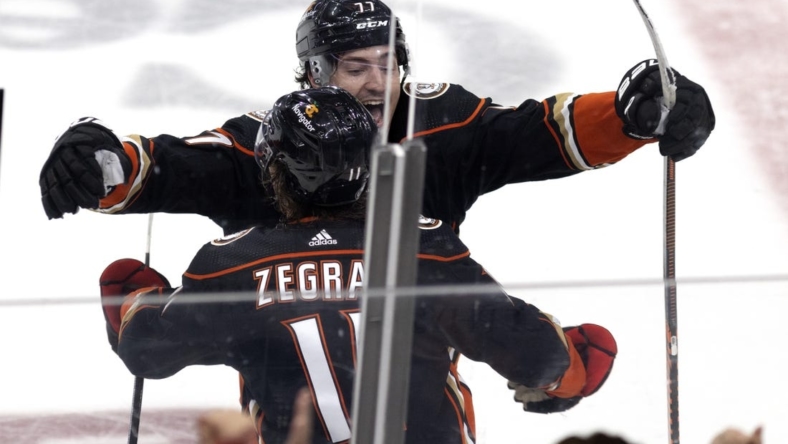 Oct 30, 2022; Anaheim, California, USA; Anaheim Ducks center Trevor Zegras (11) celebrates the game-winning overtime goal with right wing Frank Vatrano (77) against the Toronto Maple Leafs at Honda Center. The Ducks won 4-3 in overtime. Mandatory Credit: Jason Parkhurst-USA TODAY Sports
