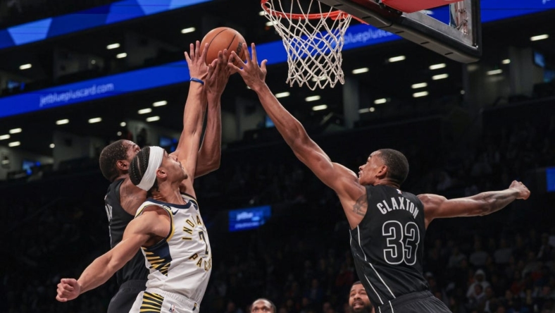 Oct 31, 2022; Brooklyn, New York, USA; Indiana Pacers guard Andrew Nembhard (2) battles Brooklyn Nets forward Kevin Durant (7) and forward Nic Claxton (33) for the ball during the first half at Barclays Center. Mandatory Credit: Vincent Carchietta-USA TODAY Sports
