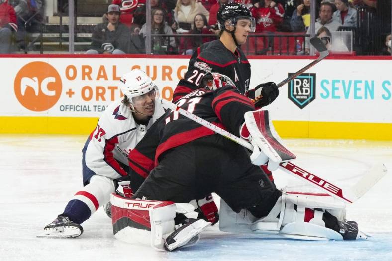 Oct 31, 2022; Raleigh, North Carolina, USA; Washington Capitals center Dylan Strome (17) scores a goal past Carolina Hurricanes goaltender Frederik Andersen (31) and center Sebastian Aho (20) during the second period at PNC Arena. Mandatory Credit: James Guillory-USA TODAY Sports