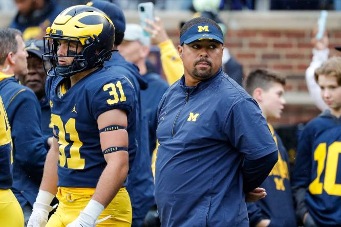 Former Michigan legend and current running backs coach Mike Hart carted off  sideline with apparent seizure