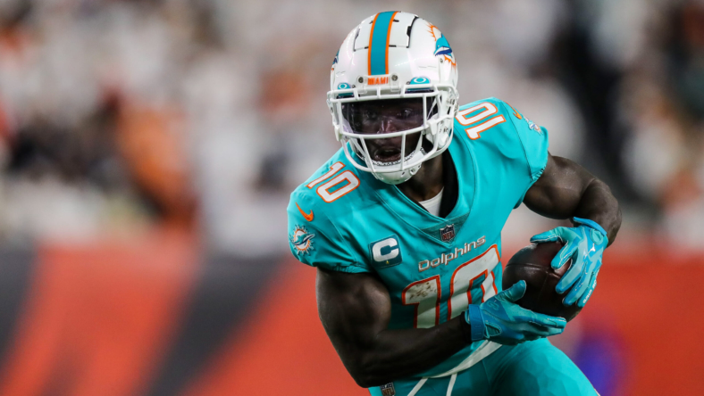 Miami Dolphins star Tyreek Hill in walking boot after suffering foot injury