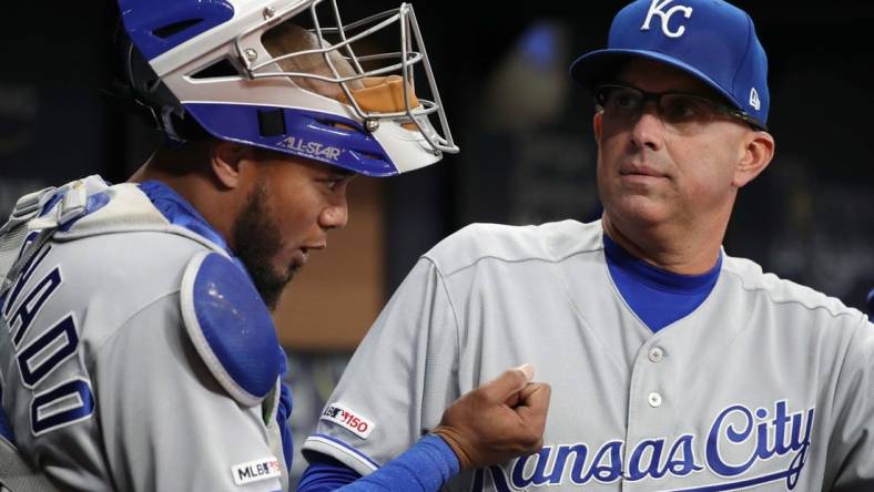 Apr 22, 2019; St. Petersburg, FL, USA; Kansas City Royals  catching coach Pedro Grifol (7) talks with catcher Martin Maldonado (16) at Tropicana Field. Mandatory Credit: Kim Klement-USA TODAY Sports