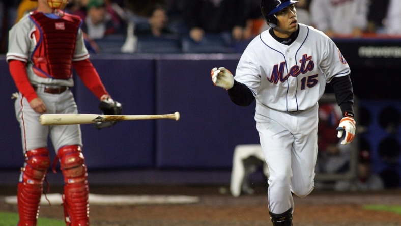 The Mets Carlos Beltran tosses his bat aside after hitting a three-run homer in the 7th inning, as Phillies catcher Mike Lieberthal looks on in Queens on May 2, 2005.

75j00kue