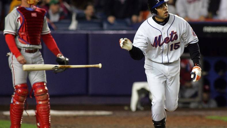 The Mets Carlos Beltran tosses his bat aside after hitting a three-run homer in the 7th inning, as Phillies catcher Mike Lieberthal looks on in Queens on May 2, 2005.

75j00kue