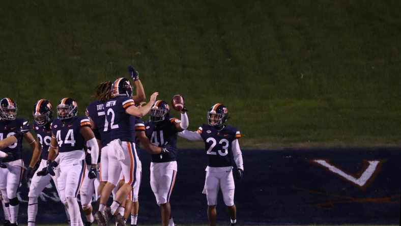 Nov 21, 2020; Charlottesville, Virginia, USA; Virginia Cavaliers linebacker D'Sean Perry (41) celebrates with teammates after returning an interception for a touchdown against the Abilene Christian Wildcats on the game's final play at Scott Stadium. Mandatory Credit: Geoff Burke-USA TODAY Sports