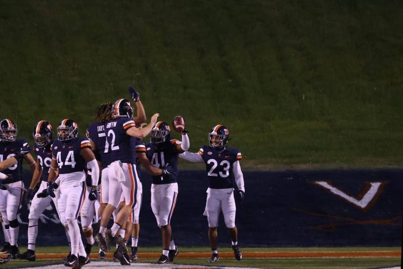 Nov 21, 2020; Charlottesville, Virginia, USA; Virginia Cavaliers linebacker D'Sean Perry (41) celebrates with teammates after returning an interception for a touchdown against the Abilene Christian Wildcats on the game's final play at Scott Stadium. Mandatory Credit: Geoff Burke-USA TODAY Sports