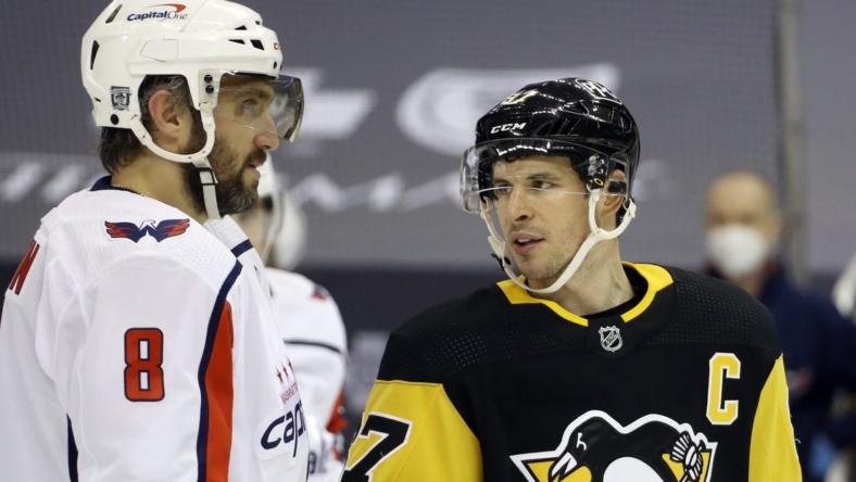 Feb 14, 2021; Pittsburgh, Pennsylvania, USA;  Washington Capitals left wing Alex Ovechkin (8) and Pittsburgh Penguins center Sidney Crosby (87) talk before a face-off during the second period at PPG Paints Arena. Mandatory Credit: Charles LeClaire-USA TODAY Sports