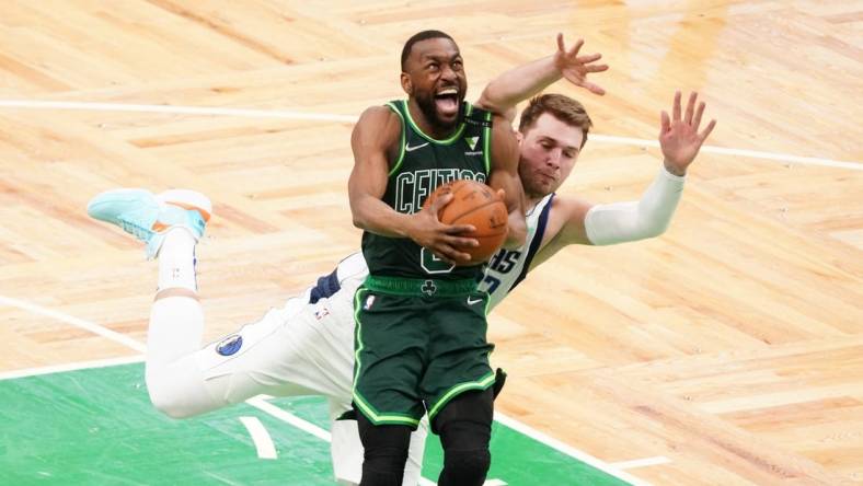 Mar 31, 2021; Boston, Massachusetts, USA; Boston Celtics guard Kemba Walker (8) is fouled by Dallas Mavericks guard Luka Doncic (77) during the fourth quarter at TD Garden. Mandatory Credit: David Butler II-USA TODAY Sports